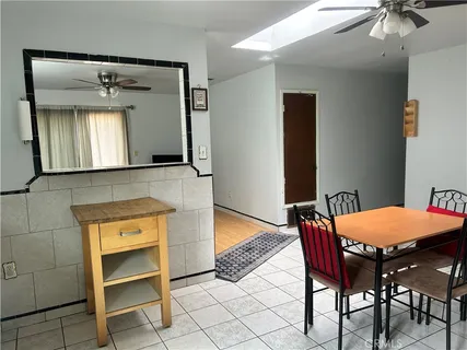 a dining room with a sink and a mirror