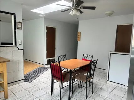 a dining room with furniture and window