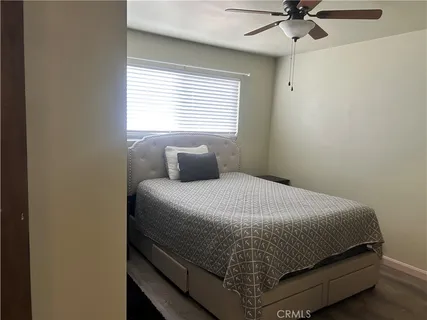a bedroom with a bed and window