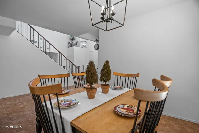 a view of a dining room and livingroom with furniture wooden floor and a chandelier