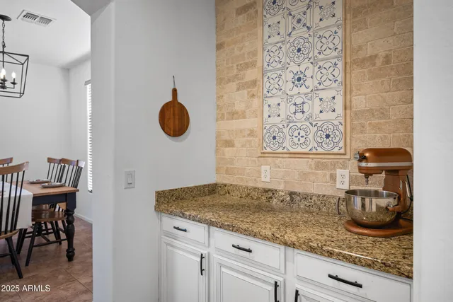 a kitchen with granite countertop a sink and cabinets