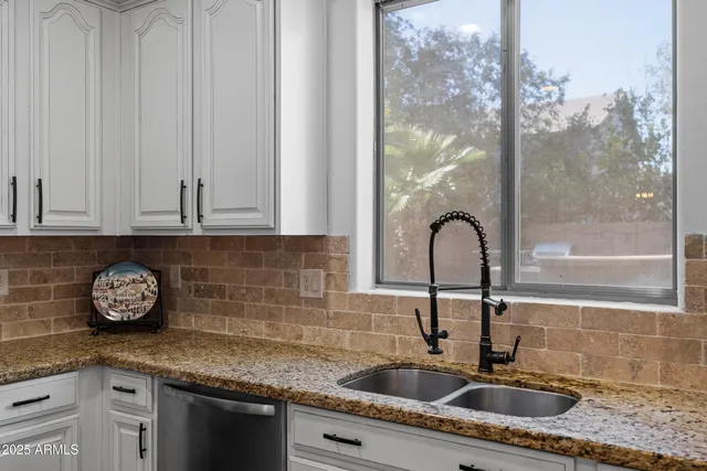 a kitchen with stainless steel appliances granite countertop a stove and a sink