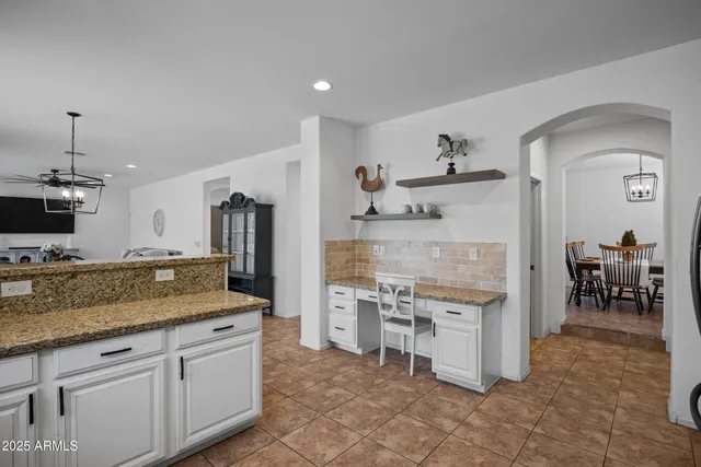 a view of a hallway with wooden floor and a livingroom