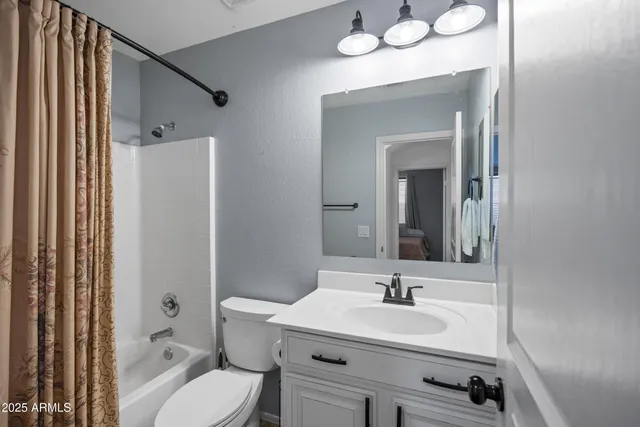 a view of staircase with lots of frames on wall and wooden floor