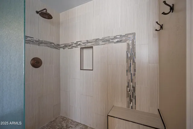 a bedroom with a bed table chair and a window