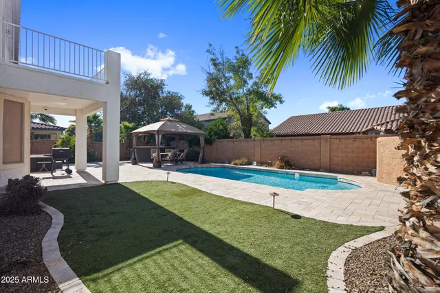 a backyard of a house with table and chairs