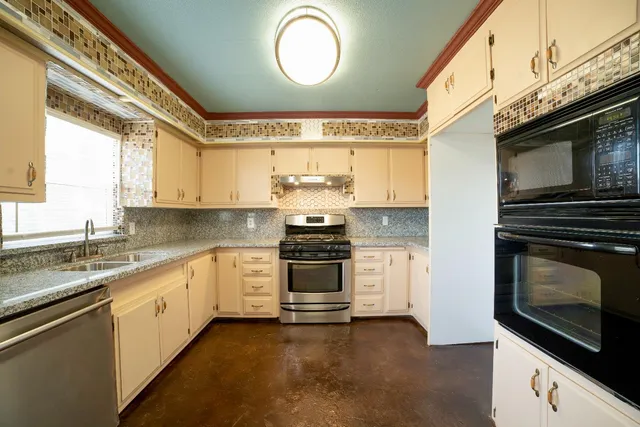 a kitchen with stainless steel appliances a stove a microwave and cabinets