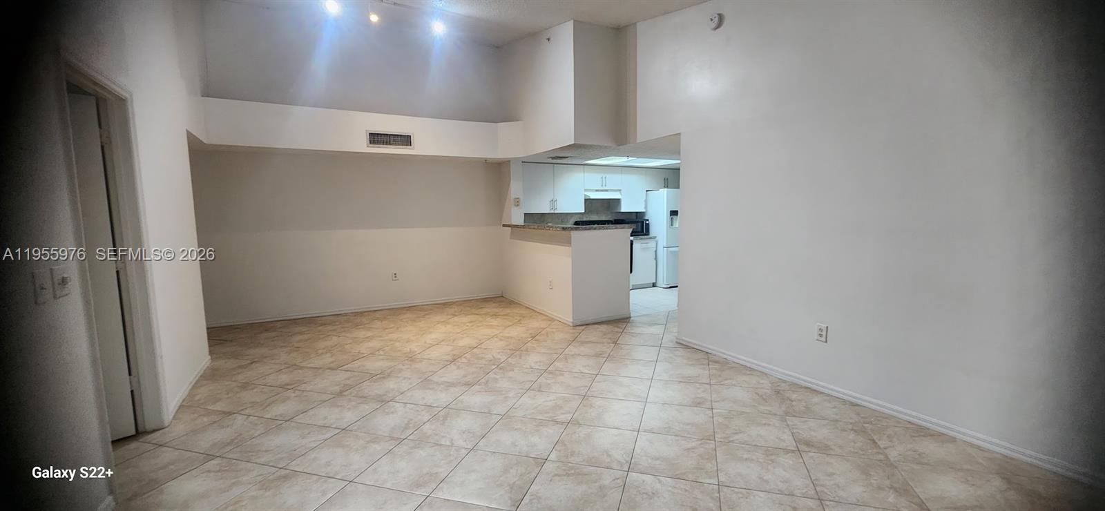 5011 Wiles Road, Unit 306 Coconut Creek, FL 33073 - Photo 9 of 17 a view of kitchen and white walls