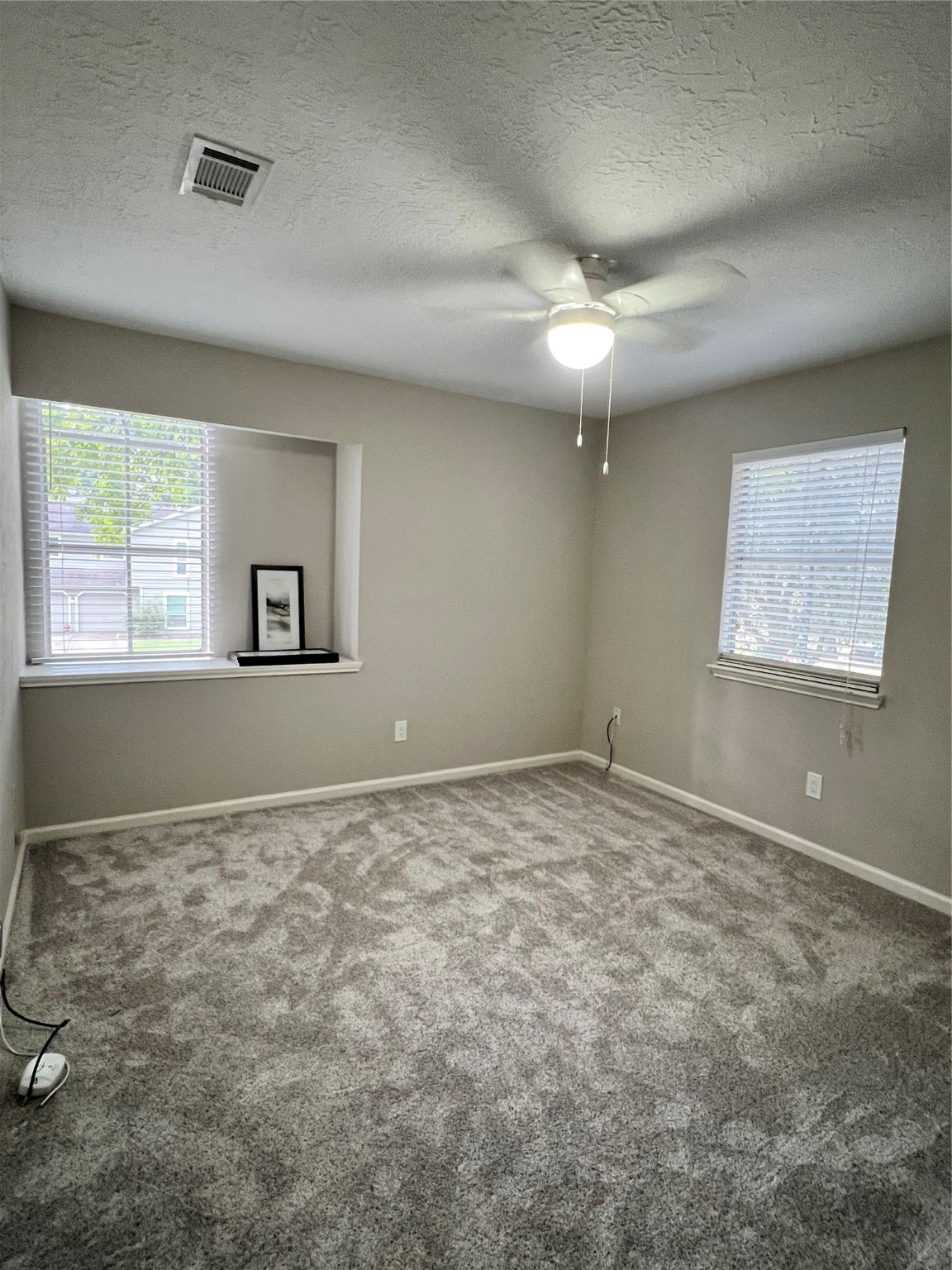 5 Spurwood Court The Woodlands, TX 77381 - Photo 12 of 16 a view of an empty room with a window