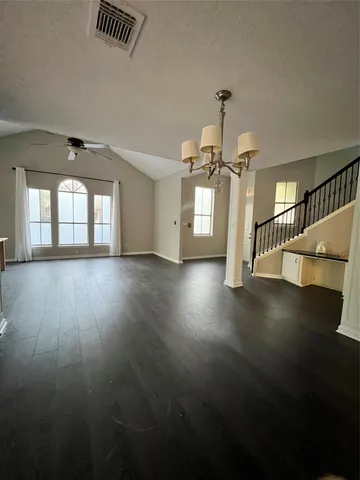 a view of a room with wooden floor