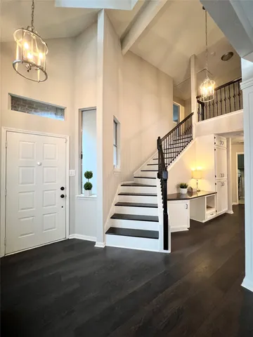 a view of entryway and hall with wooden floor