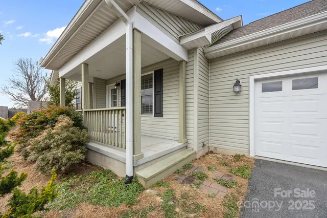a view of a house with a small yard and wooden fence