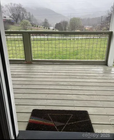 a view of a wooden deck and a yard