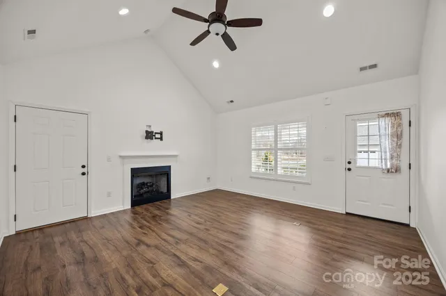 a view of a kitchen with a sink stove cabinets and empty room