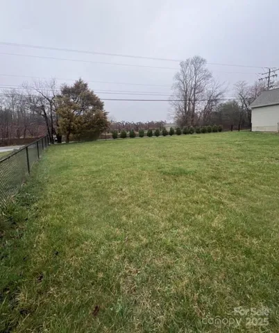 a view of a room with wooden floor and windows