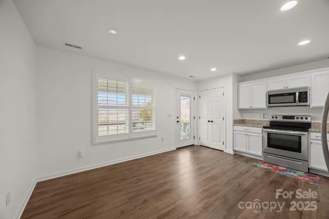 a kitchen with a refrigerator and a sink