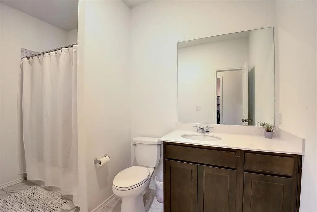 171 Santa Julia Kyle, TX 78640 - Photo 15 of 18 Full bath featuring a shower with shower curtain and vanity