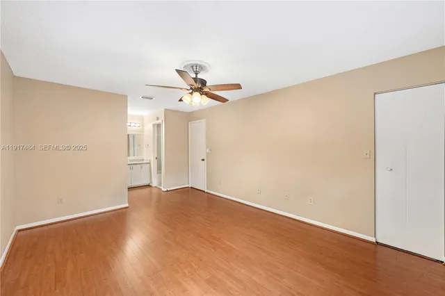 a view of empty room with wooden floor
