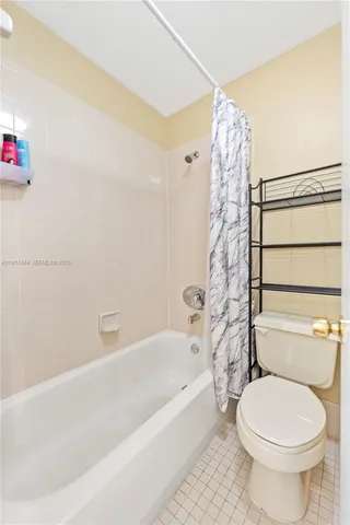 a bathroom with a toilet and a bathtub