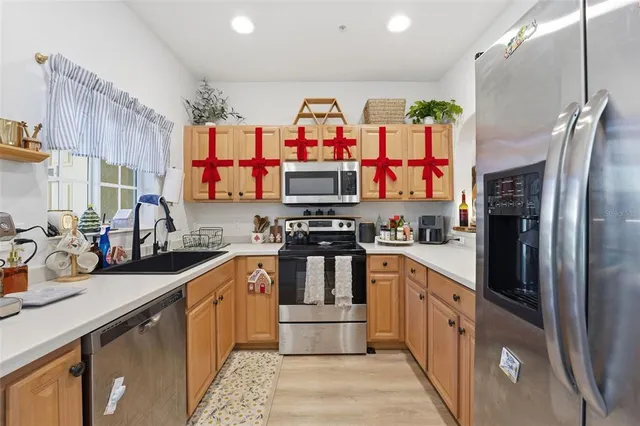 a kitchen with stainless steel appliances a refrigerator and a stove top oven
