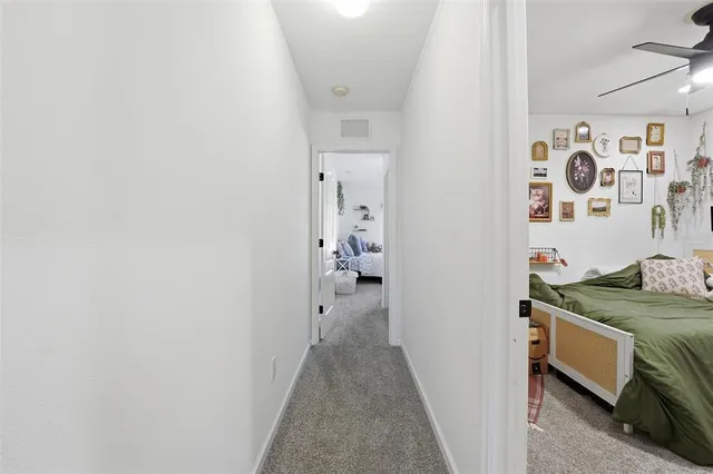 a bedroom with a bed and a desk in it