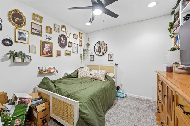 a bedroom with a bed and painting on the wall
