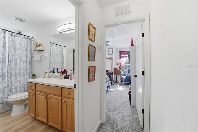 a bathroom with a sink mirror and toilet