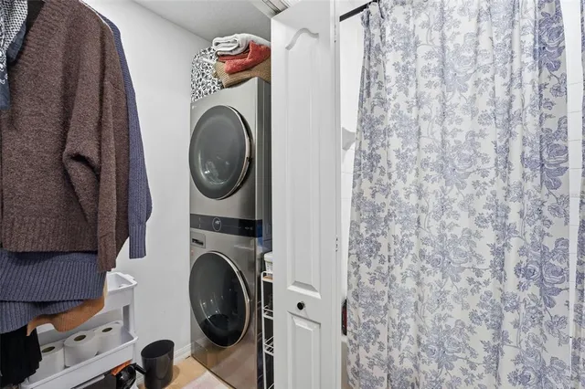 a bedroom with a bed a couch and a flat screen tv