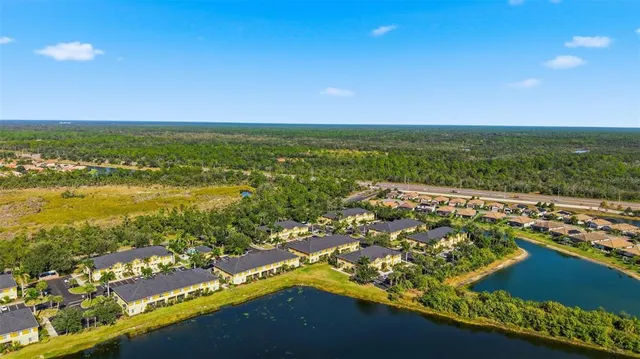 an aerial view of residential houses with outdoor space