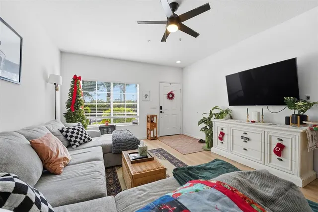 a living room with furniture and a book shelf