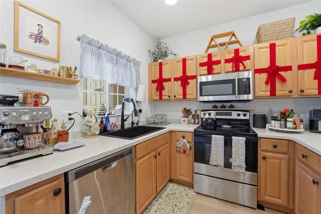 a kitchen with stainless steel appliances granite countertop a refrigerator and a sink