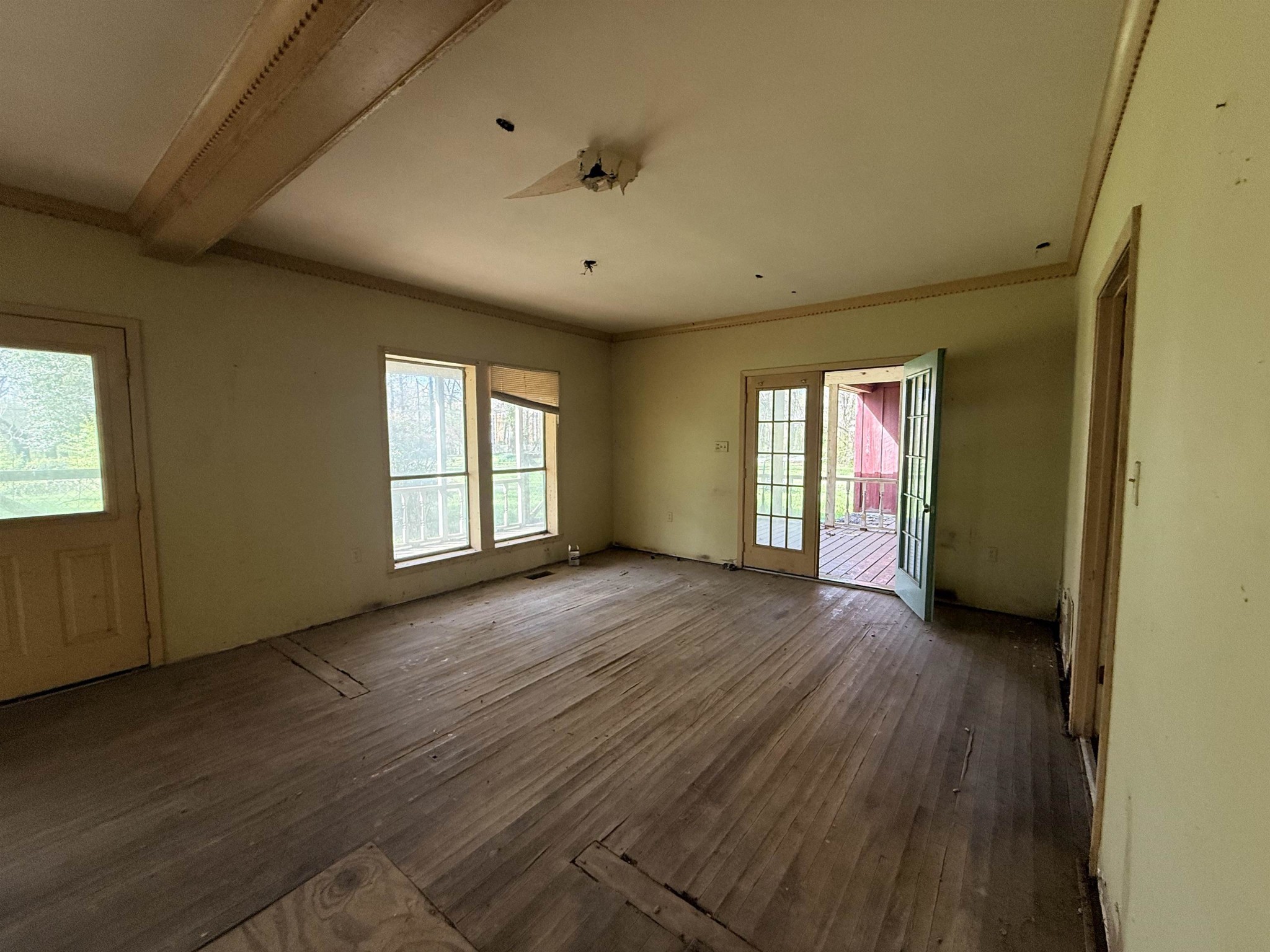 890 Craft Road Memphis, TN 38116 - Photo 11 of 15 a view of an empty room with wooden floor and a window