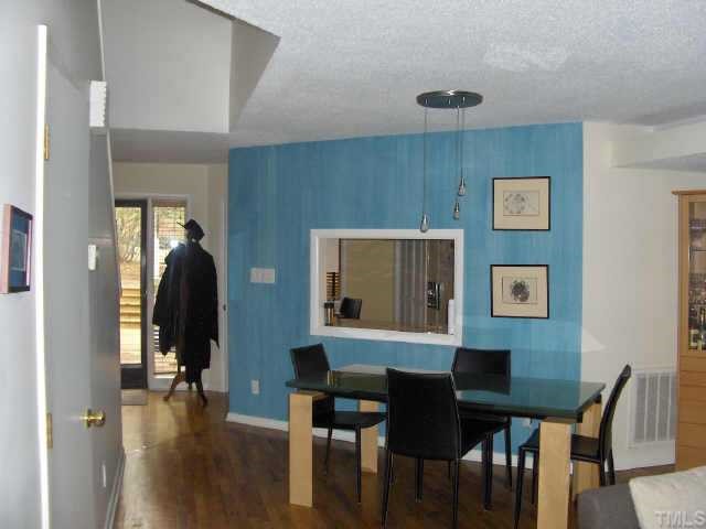 63 Stoneridge Road Durham, NC 27705 - Photo 2 of 9 a view of a dining room with furniture and wooden floor