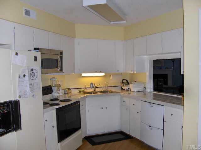 63 Stoneridge Road Durham, NC 27705 - Photo 7 of 9 a kitchen with stainless steel appliances a stove a sink a stove and a refrigerator