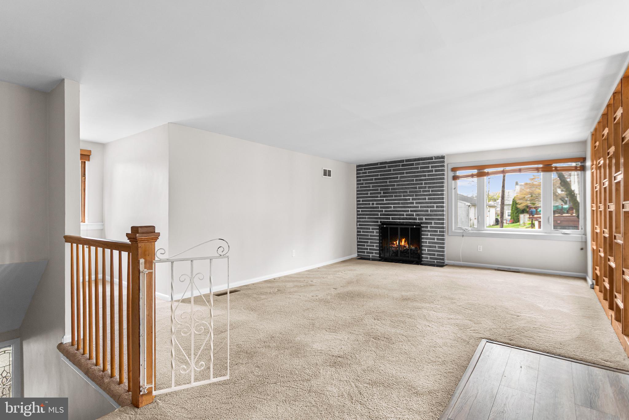 118 Powell Road Springfield, PA 19064 - Photo 19 of 33 a view of an empty room with a fireplace and a window