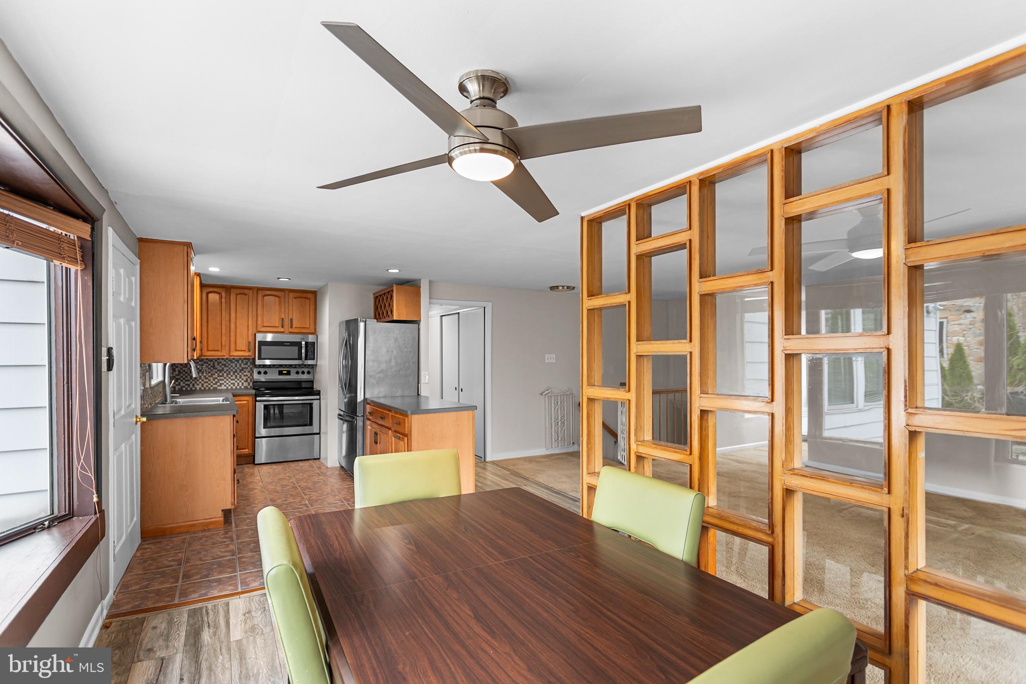 118 Powell Road Springfield, PA 19064 - Photo 21 of 33 a living room with stainless steel appliances wooden floor and a large window