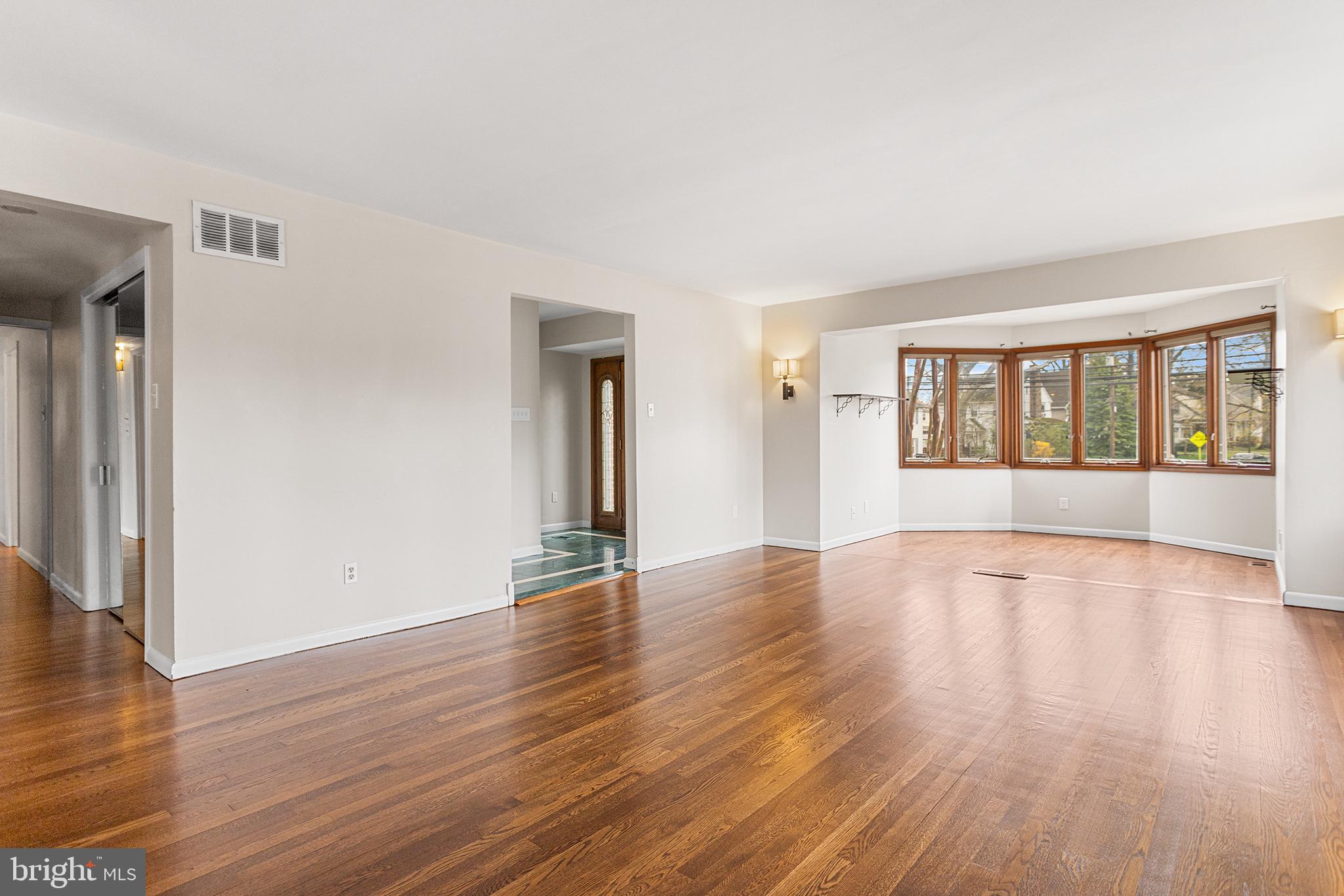 118 Powell Road Springfield, PA 19064 - Photo 4 of 33 a view of an empty room with wooden floor and a window