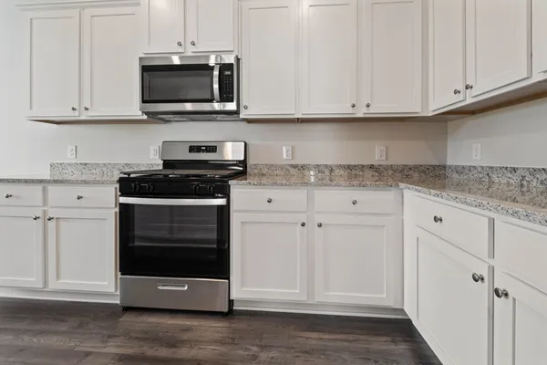 a kitchen with stainless steel appliances granite countertop white cabinets granite and granite counter tops
