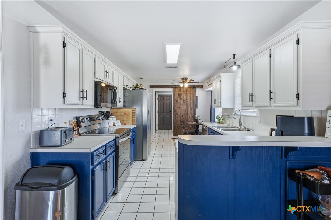 1601 Citation Loop Harker Heights, TX 76548 - Photo 17 of 42 a kitchen with kitchen island granite countertop a sink stove and cabinets