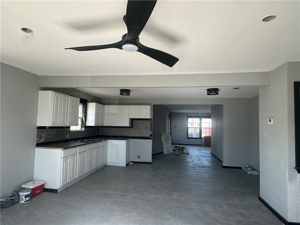 203 East Blair Street Three Rivers, TX 78071 - Photo 5 of 7 a kitchen with granite countertop a sink stainless steel appliances and cabinets