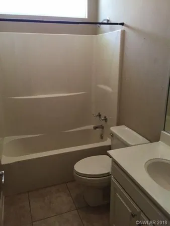 a bathroom with a toilet a sink and bathtub