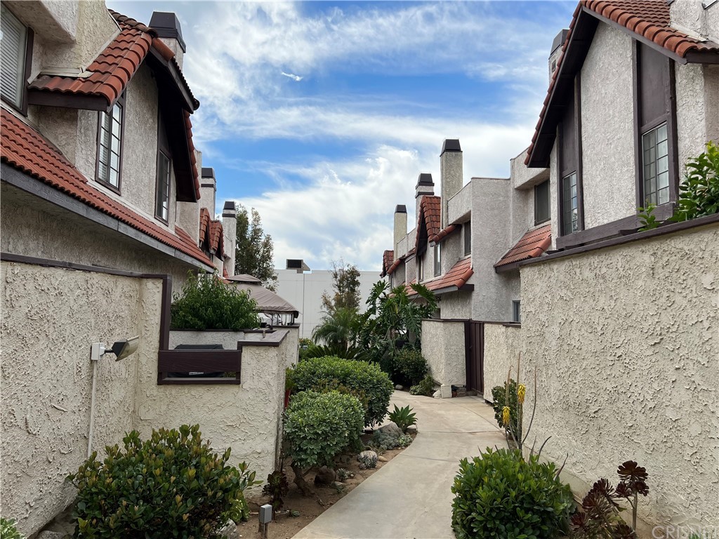 12330 Osborne Street, Unit 39 Pacoima, CA 91331 - Photo 1 of 1 a front view of a house with a garden