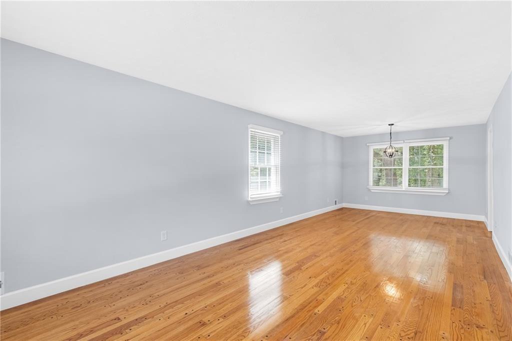 4373 Buckingham Circle Decatur, GA 30035 - Photo 11 of 40 an empty room with wooden floor and windows