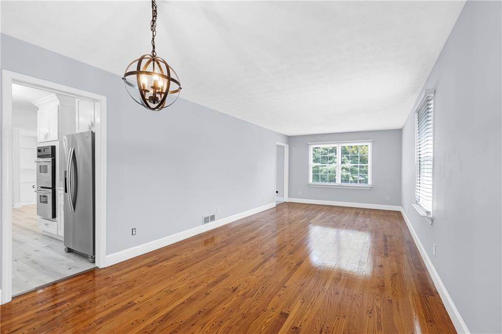 4373 Buckingham Circle Decatur, GA 30035 - Photo 12 of 40 an empty room with wooden floor and windows