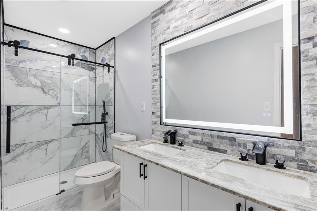 4373 Buckingham Circle Decatur, GA 30035 - Photo 14 of 40 a bathroom with a granite countertop sink toilet and shower