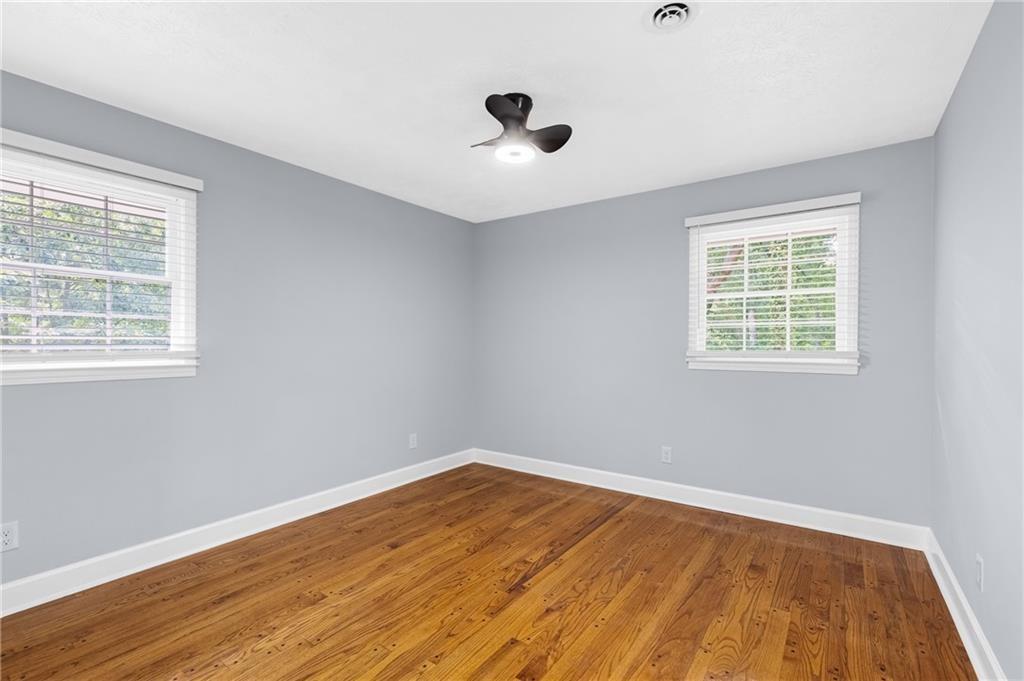 4373 Buckingham Circle Decatur, GA 30035 - Photo 15 of 40 a view of an empty room with wooden floor and a window