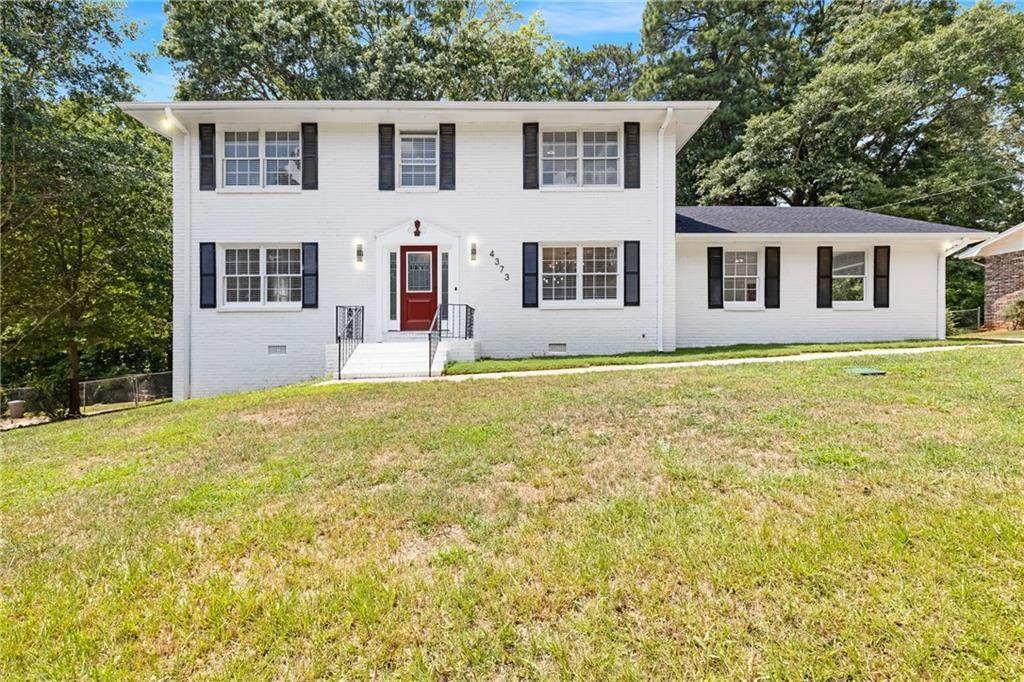 4373 Buckingham Circle Decatur, GA 30035 - Photo 2 of 40 a large white house with a large pool