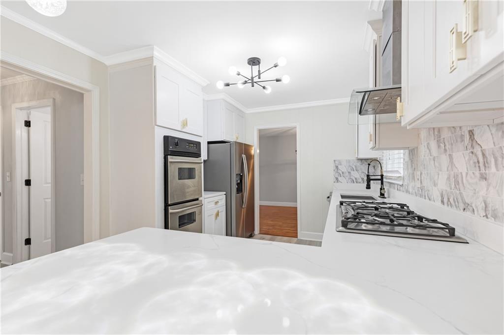 4373 Buckingham Circle Decatur, GA 30035 - Photo 4 of 40 a bedroom with a bed and a chandelier