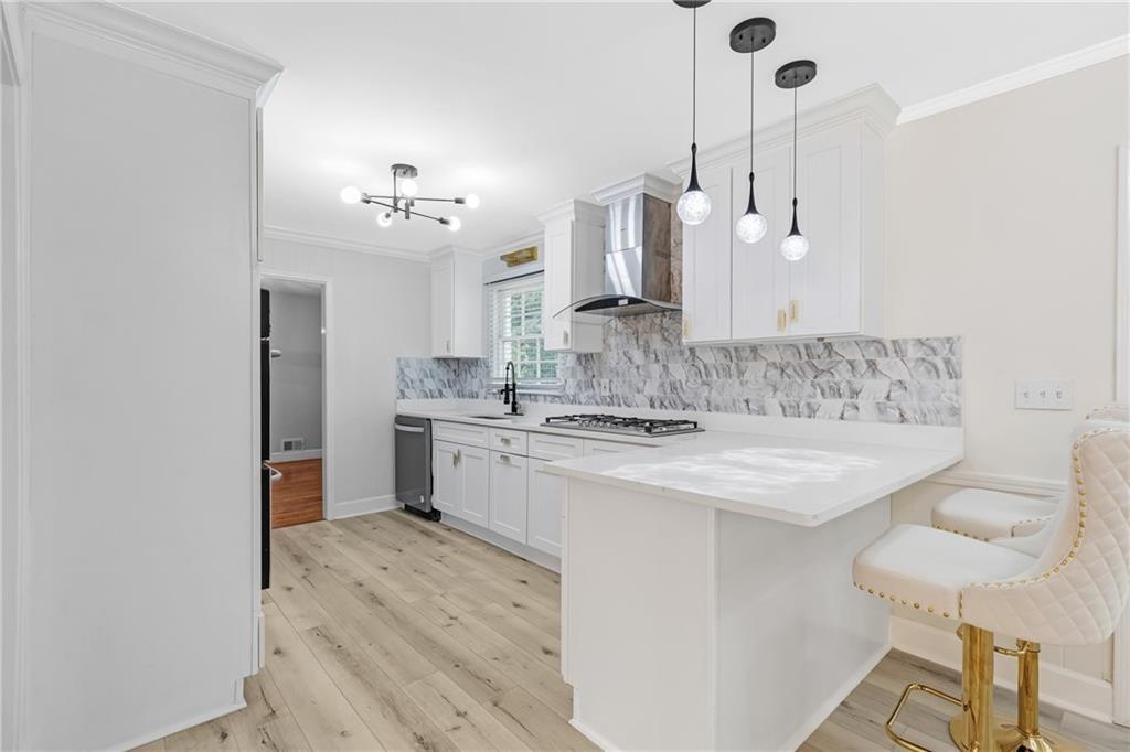 4373 Buckingham Circle Decatur, GA 30035 - Photo 6 of 40 a kitchen with kitchen island a sink stove and white cabinets