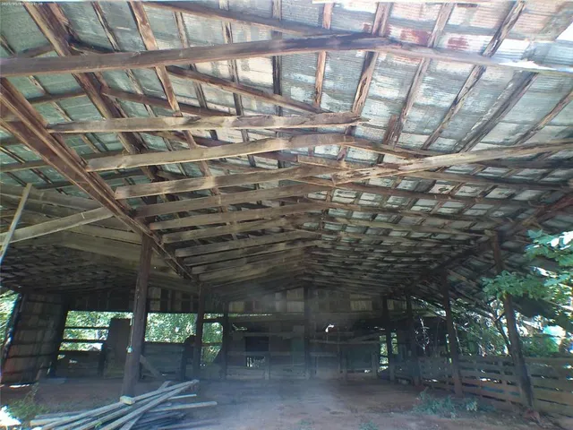a kitchen with stainless steel appliances kitchen island granite countertop wooden cabinets and a refrigerator